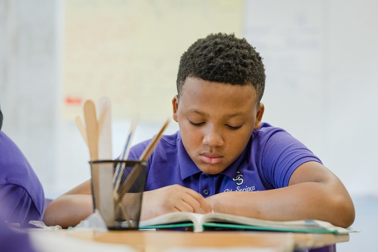 City Springs student reading at desk